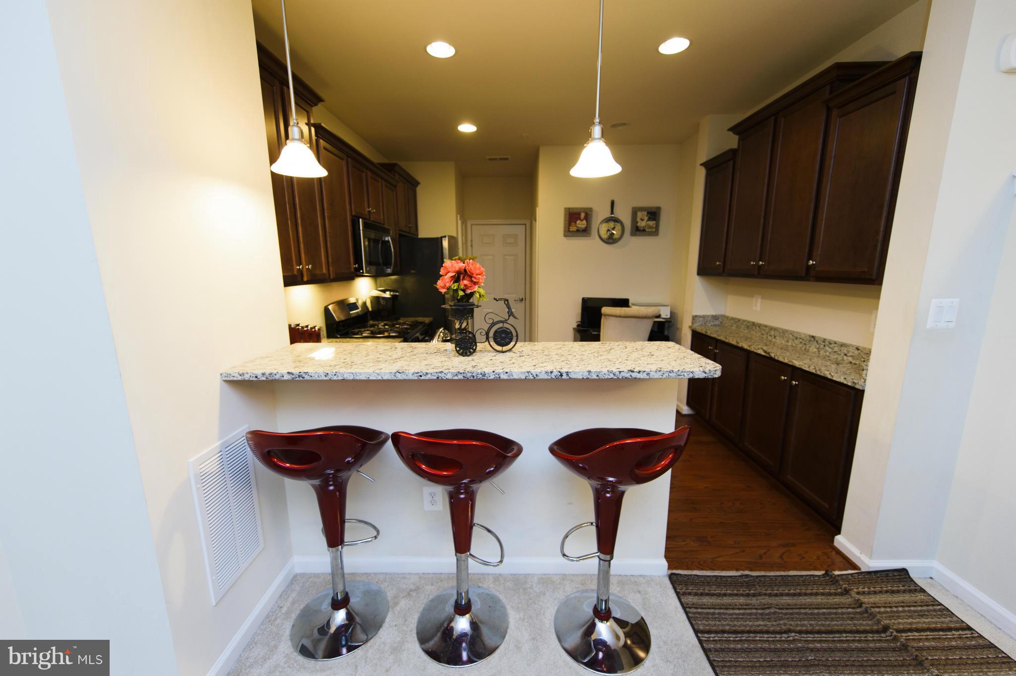 4878 Dane Ridge Circle, Unit 123 Woodbridge, VA 22193 - Photo 4 of 21 a kitchen with granite countertop a sink and cabinets