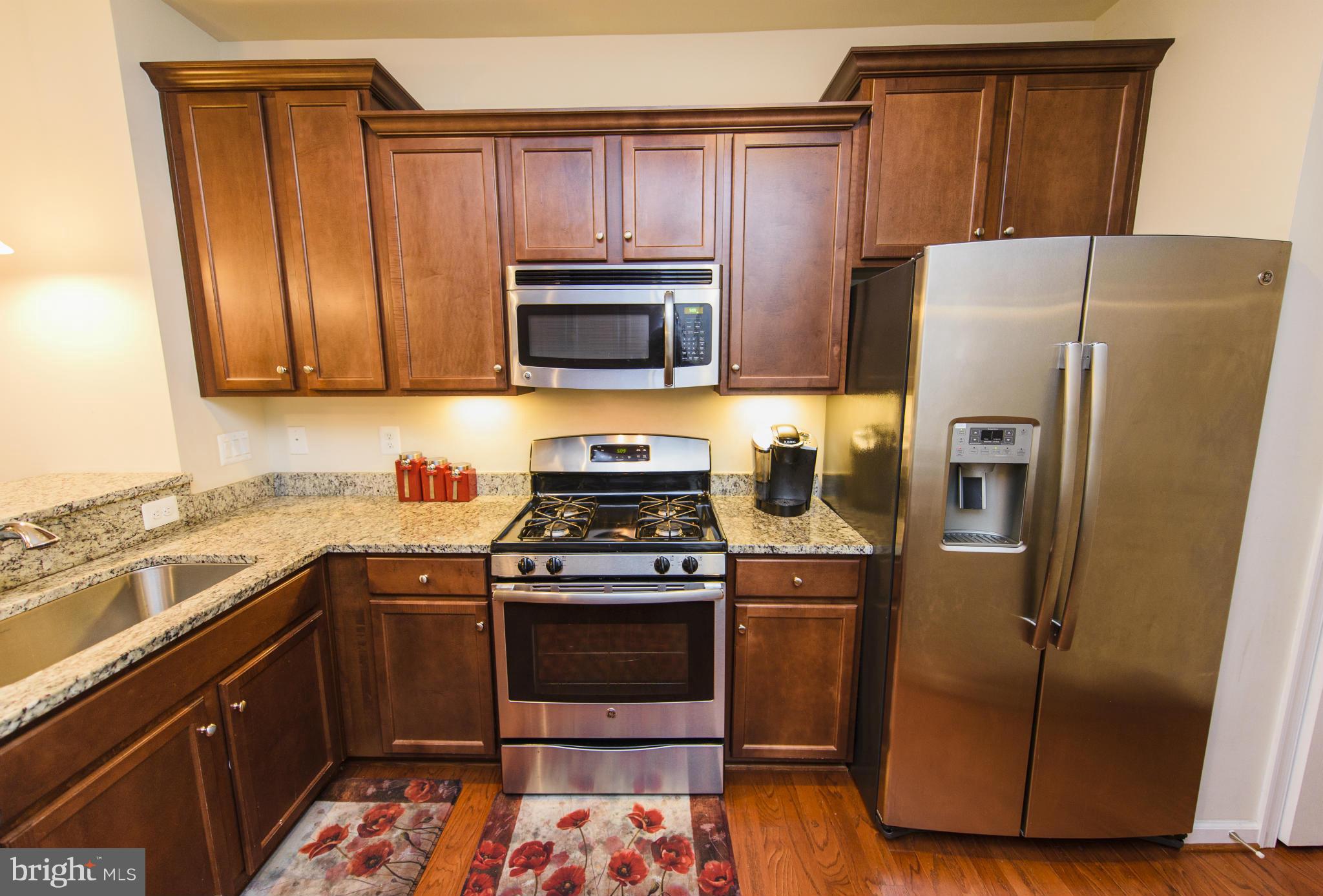 4878 Dane Ridge Circle, Unit 123 Woodbridge, VA 22193 - Photo 7 of 21 a kitchen with a refrigerator sink and microwave