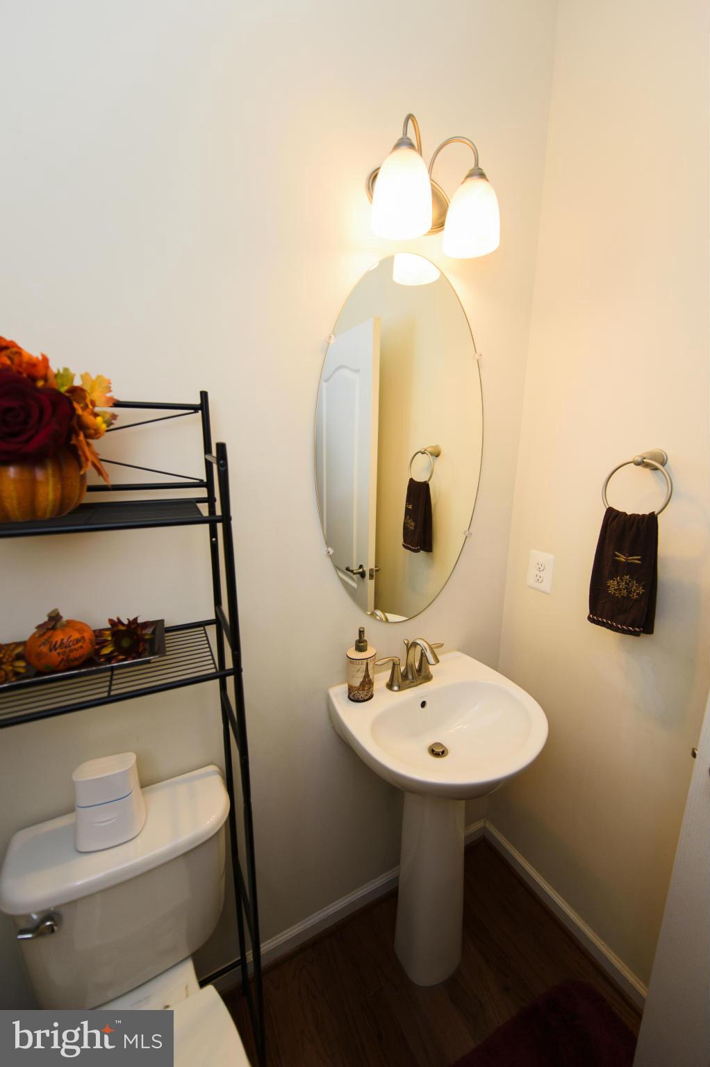 4878 Dane Ridge Circle, Unit 123 Woodbridge, VA 22193 - Photo 10 of 21 a bathroom with a toilet sink and mirror