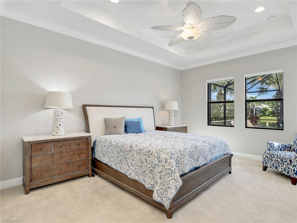 2079 Antigua Lane Naples, FL 34120 - Photo 27 of 44 Carpeted bedroom with a tray ceiling, ornamental molding, a ceiling fan, and recessed lighting