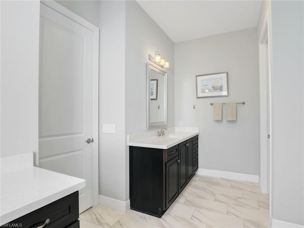 2079 Antigua Lane Naples, FL 34120 - Photo 32 of 44 Full bathroom featuring light marble finish floors and vanity