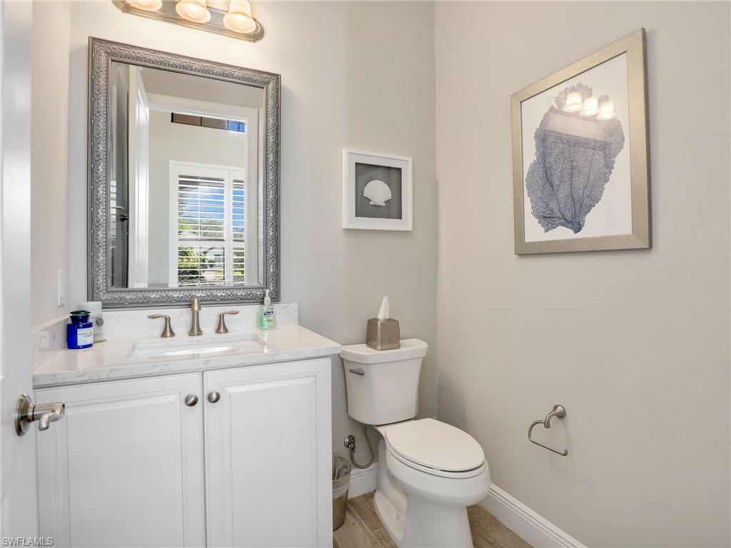 2079 Antigua Lane Naples, FL 34120 - Photo 33 of 44 Half bathroom featuring vanity and light wood finished floors