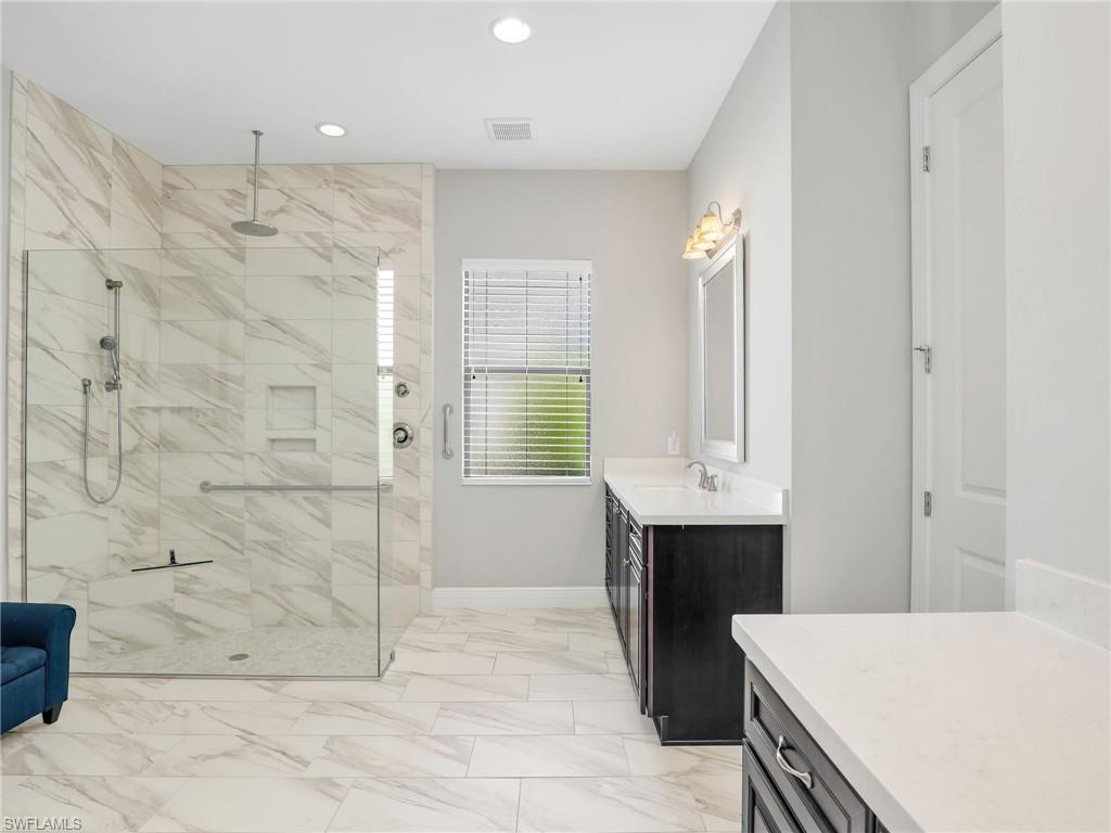 2079 Antigua Lane Naples, FL 34120 - Photo 35 of 44 Bathroom with vanity, a shower stall, recessed lighting, and light marble finish floors