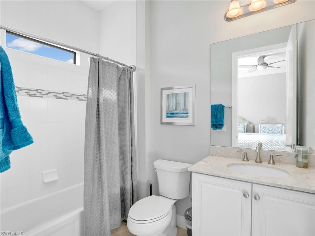 2079 Antigua Lane Naples, FL 34120 - Photo 36 of 44 Ensuite bathroom featuring shower / bath combo, vanity, and a ceiling fan
