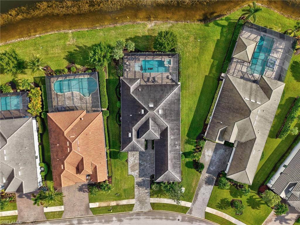 2079 Antigua Lane Naples, FL 34120 - Photo 8 of 44 Drone / aerial view of a large body of water and a pool area