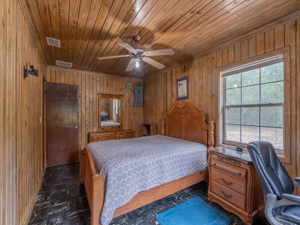 13668 Northeast 226th Avenue Road Fort McCoy, FL 32134 - Photo 14 of 37 a bedroom with a bed and a window