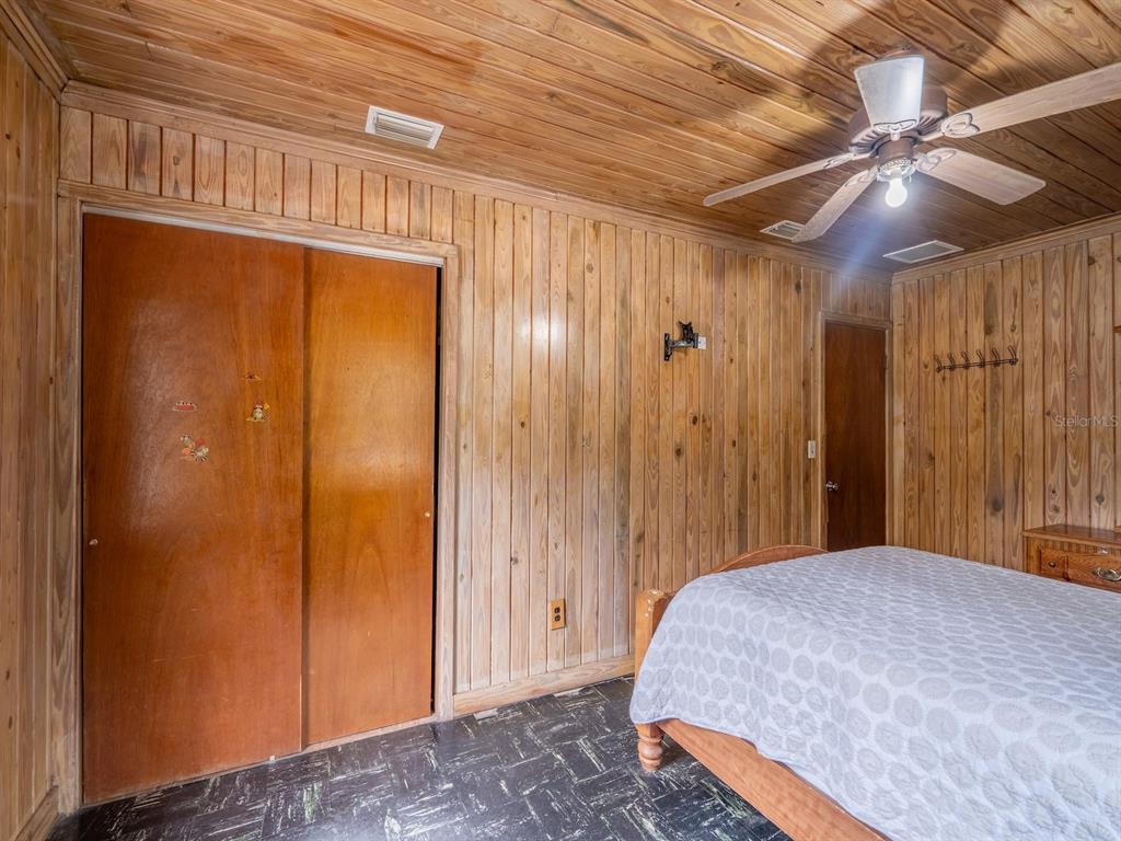 13668 Northeast 226th Avenue Road Fort McCoy, FL 32134 - Photo 15 of 37 a bedroom with a bed and a chandelier