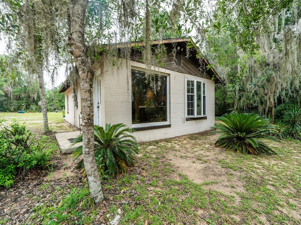 13668 Northeast 226th Avenue Road Fort McCoy, FL 32134 - Photo 19 of 37 a front view of a house with a yard