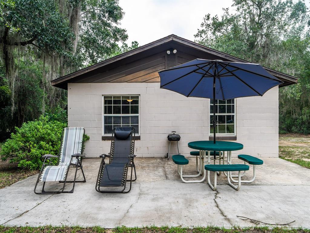 13668 Northeast 226th Avenue Road Fort McCoy, FL 32134 - Photo 21 of 37 a view of backyard with outdoor seating and trees