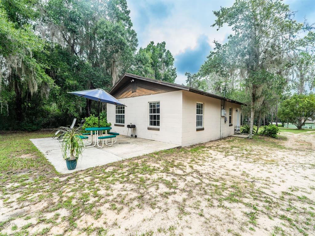 13668 Northeast 226th Avenue Road Fort McCoy, FL 32134 - Photo 3 of 37 a view of a house with backyard and sitting area