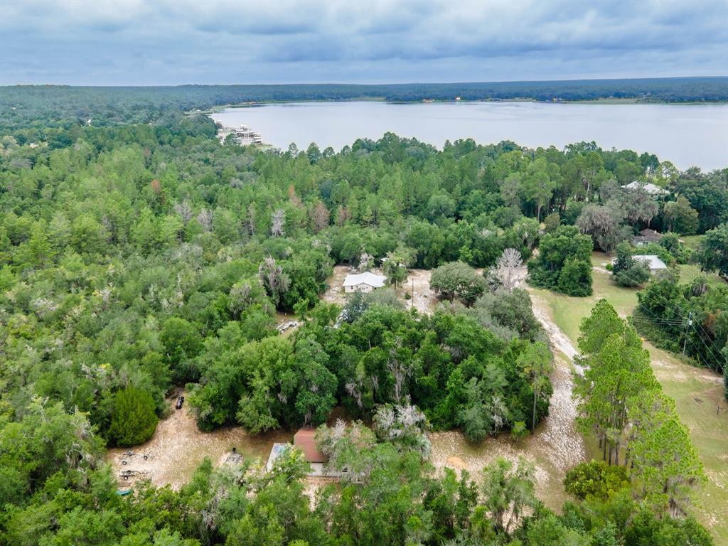13668 Northeast 226th Avenue Road Fort McCoy, FL 32134 - Photo 31 of 37 a view of a garden with a building in the background