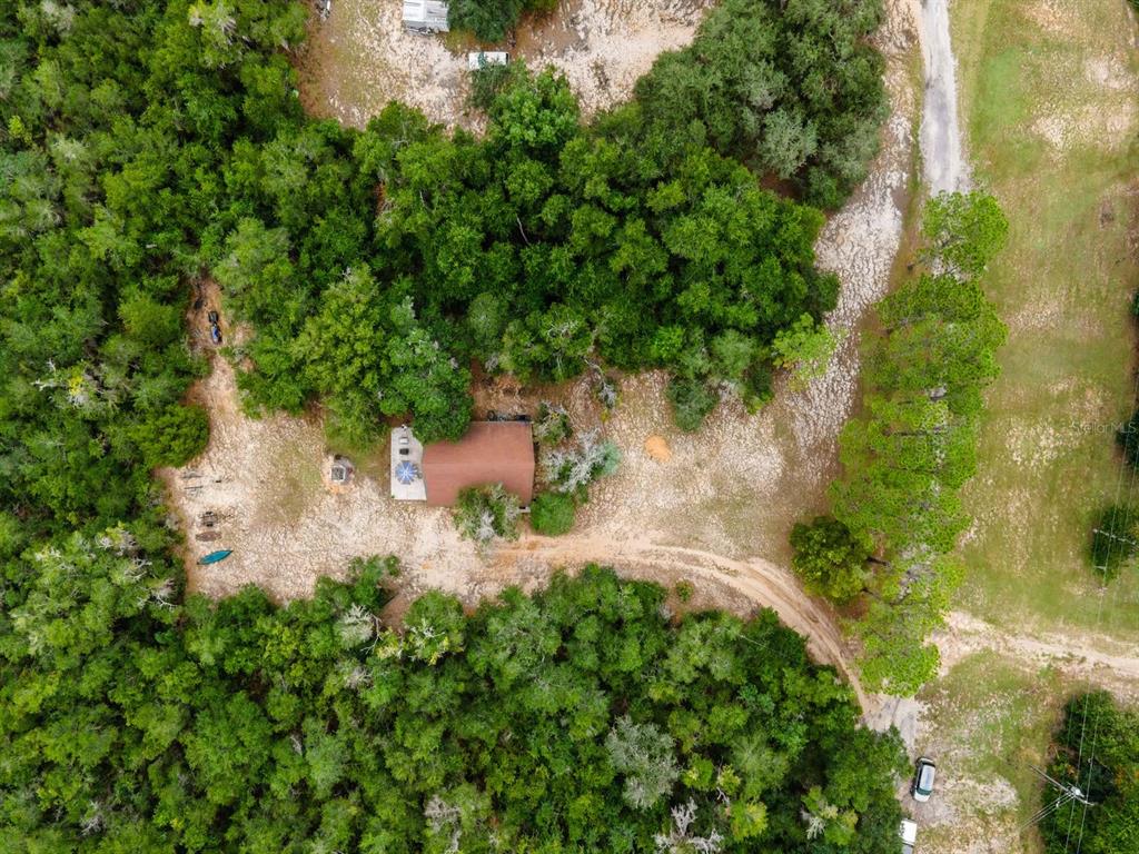 13668 Northeast 226th Avenue Road Fort McCoy, FL 32134 - Photo 33 of 37 an aerial view of residential house with outdoor space and trees all around