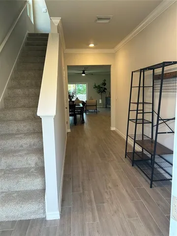 a view of living room with furniture and wooden floor