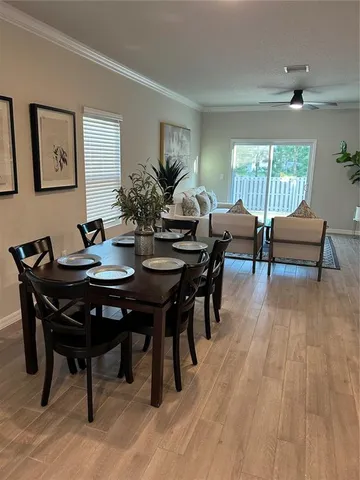 a view of a dining room with furniture and wooden floor