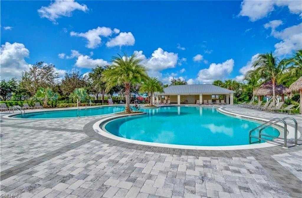 2876 Citrus Street Naples, FL 34120 - Photo 16 of 16 a view of a swimming pool with a yard