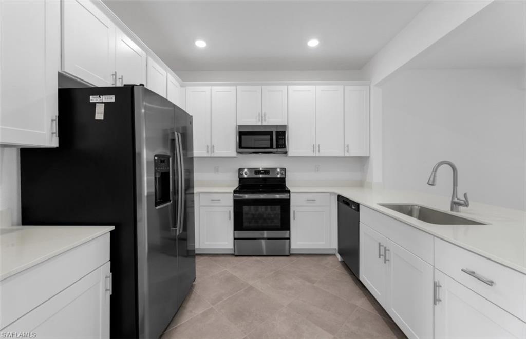 2876 Citrus Street Naples, FL 34120 - Photo 2 of 16 a kitchen with a refrigerator and a stove