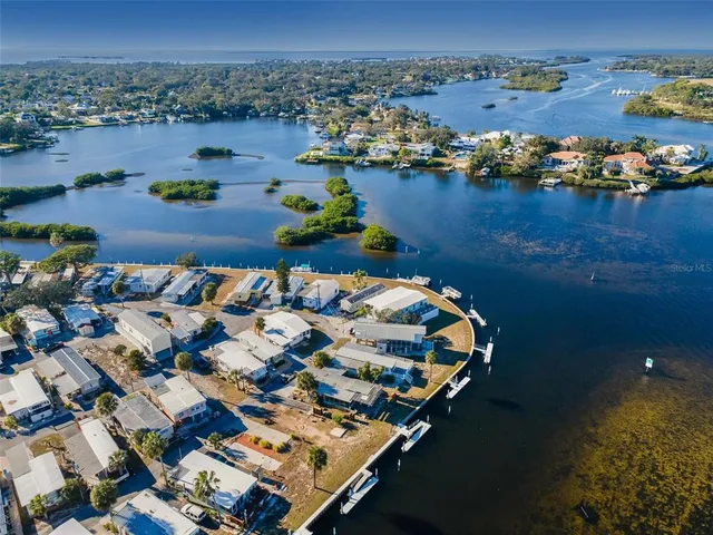 a view of a lake with a bench in front of house
