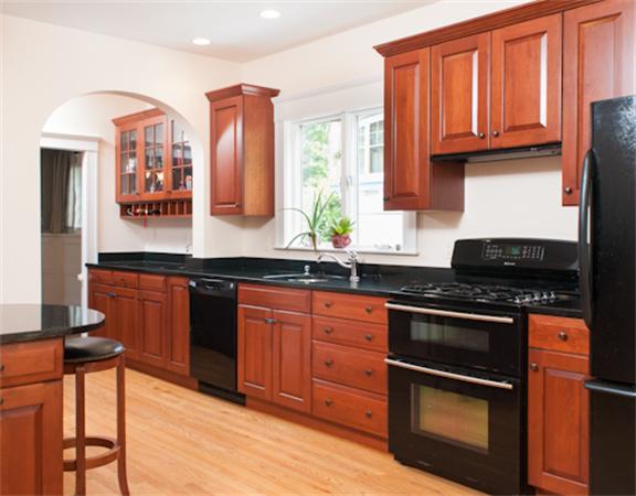 28 Manemet Road Newton, MA 02459 - Photo 8 of 15 a kitchen with stainless steel appliances granite countertop a stove a sink and a microwave