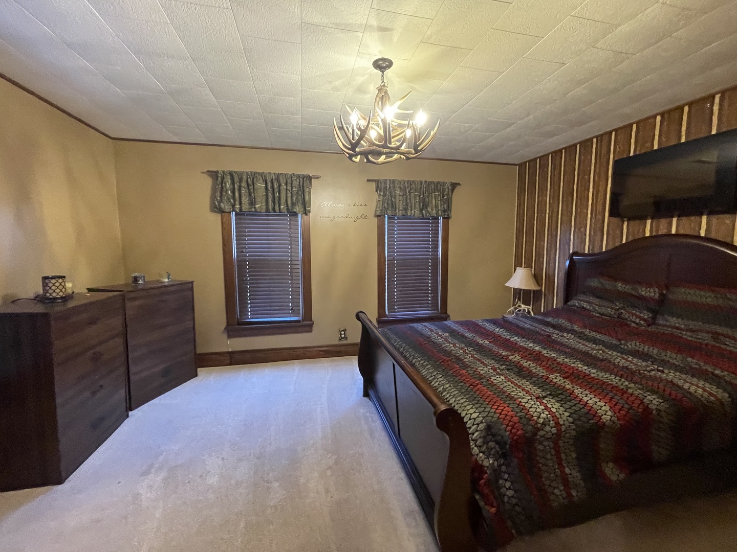 204 Locust Street Sublette, IL 61367 - Photo 13 of 17 a bed room with a bed and a chandelier