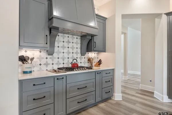 a kitchen with cabinets appliances and a wooden floor