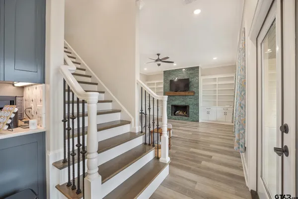 a view of entryway and hall with wooden floor