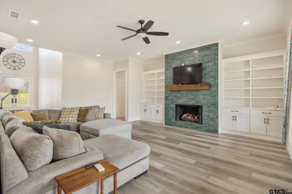 a living room with furniture and a fireplace