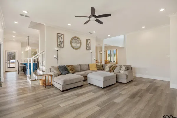 a living room with couches and kitchen view