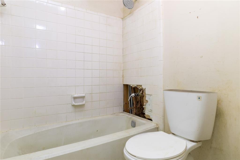 302 Countryside Place Smyrna, GA 30080 - Photo 11 of 19 a white toilet and tub sitting next to a bathroom sink