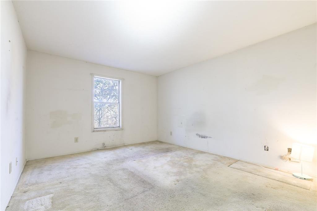 302 Countryside Place Smyrna, GA 30080 - Photo 13 of 19 an empty room with a white wall and a window