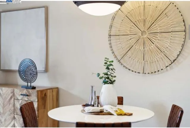 a dining room with furniture a potted plant and a chandelier
