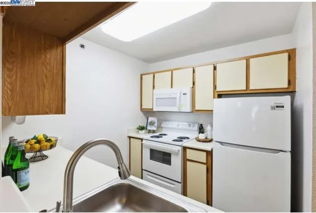 a kitchen with stainless steel appliances a refrigerator sink and cabinets