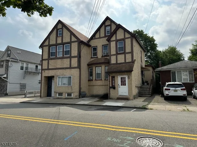 a view of a car park in front of a house
