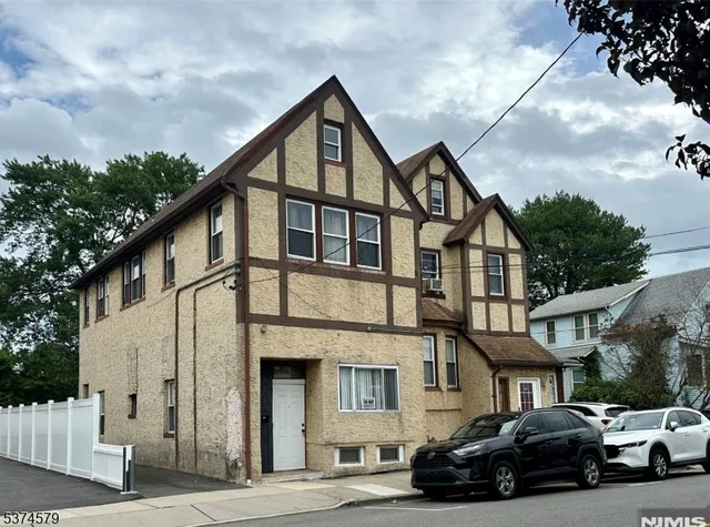 a car parked in front of a white house