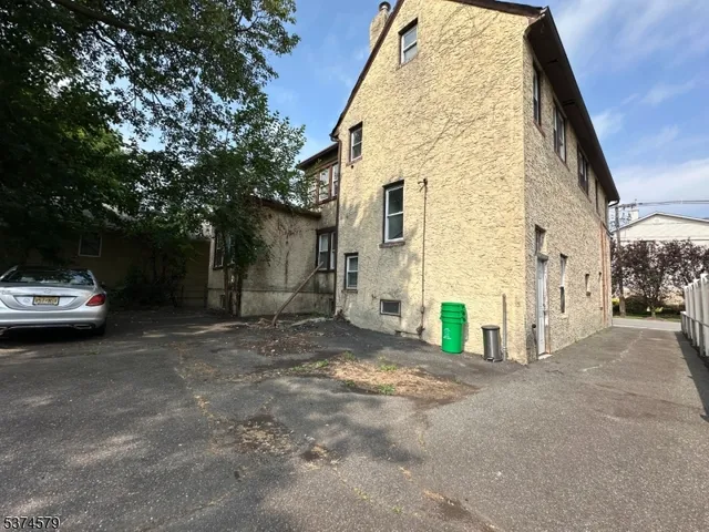 a view of a car park in front of a house