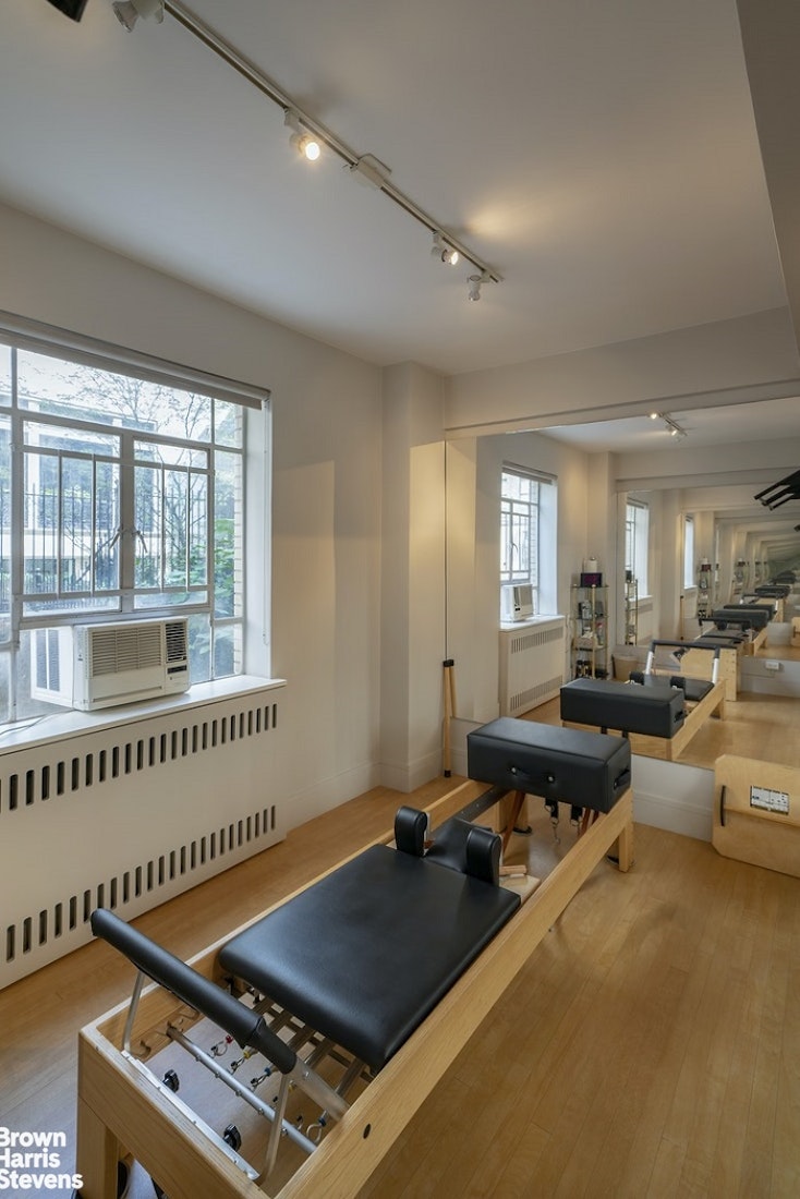 3 East 71st Street, Unit 11/12C Manhattan, NY 10021 - Photo 11 of 14 a living room with furniture gym equipment and a large window