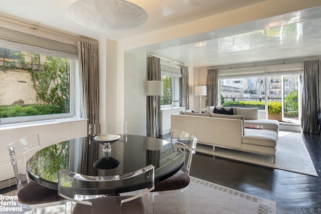 3 East 71st Street, Unit 11/12C Manhattan, NY 10021 - Photo 4 of 14 a living room with furniture and a large window