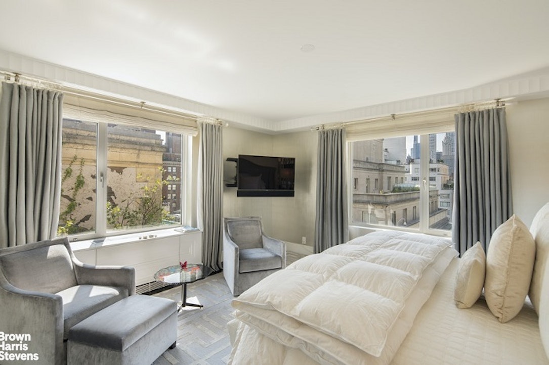 3 East 71st Street, Unit 11/12C Manhattan, NY 10021 - Photo 8 of 14 a bedroom with a large bed and a window