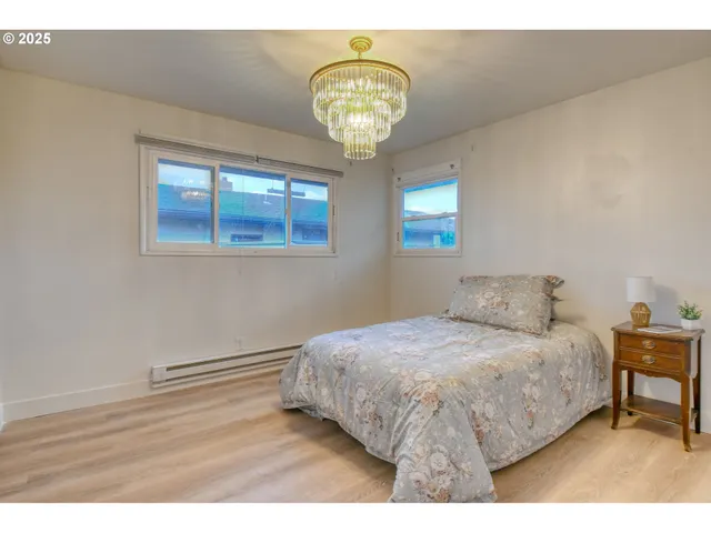 a bedroom with a bed and a chandelier