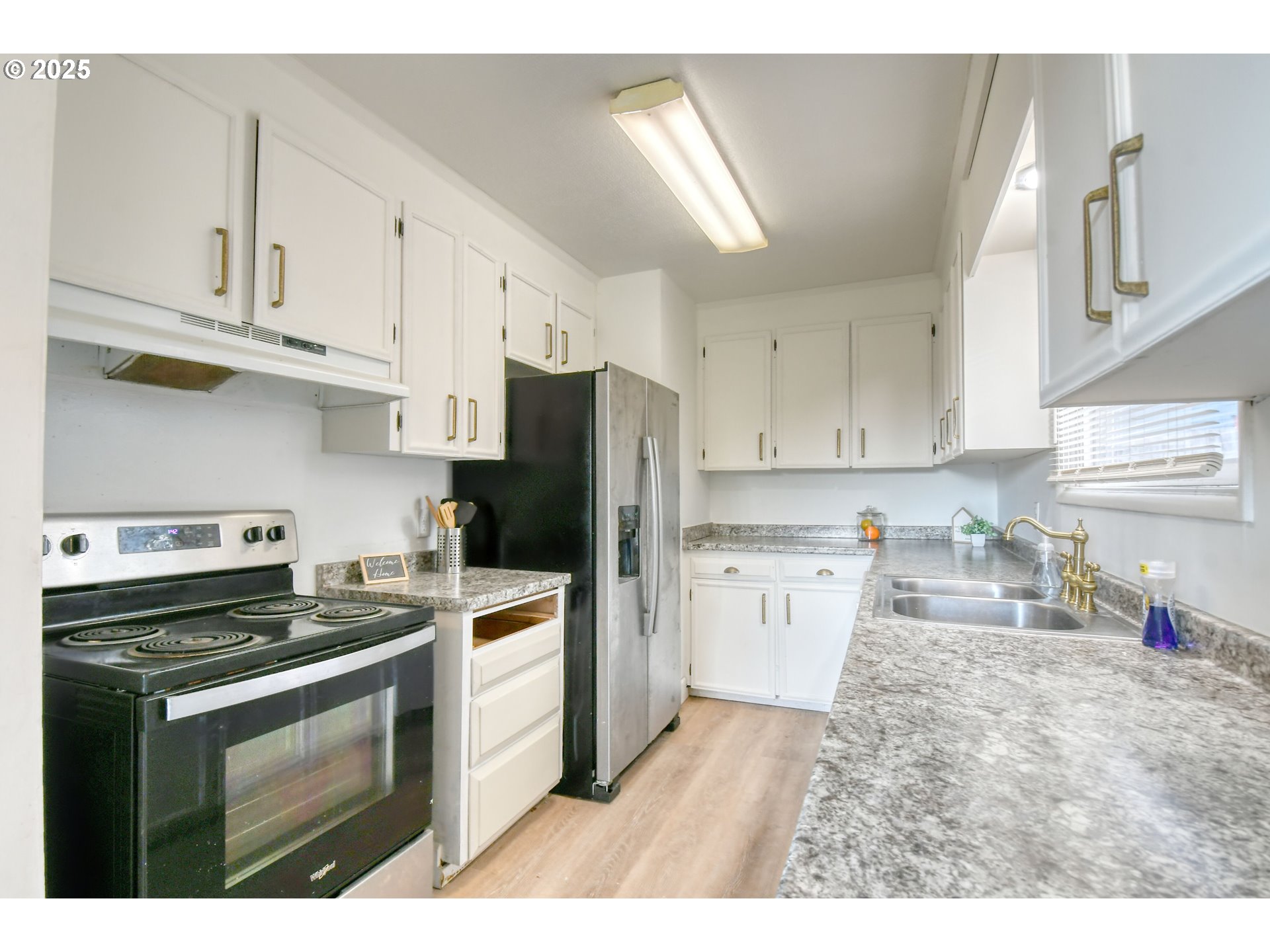 20 Northeast Nelson Drive Pendleton, OR 97801 - Photo 6 of 35 a kitchen with refrigerator a stove a sink dishwasher and cabinets with wooden floor