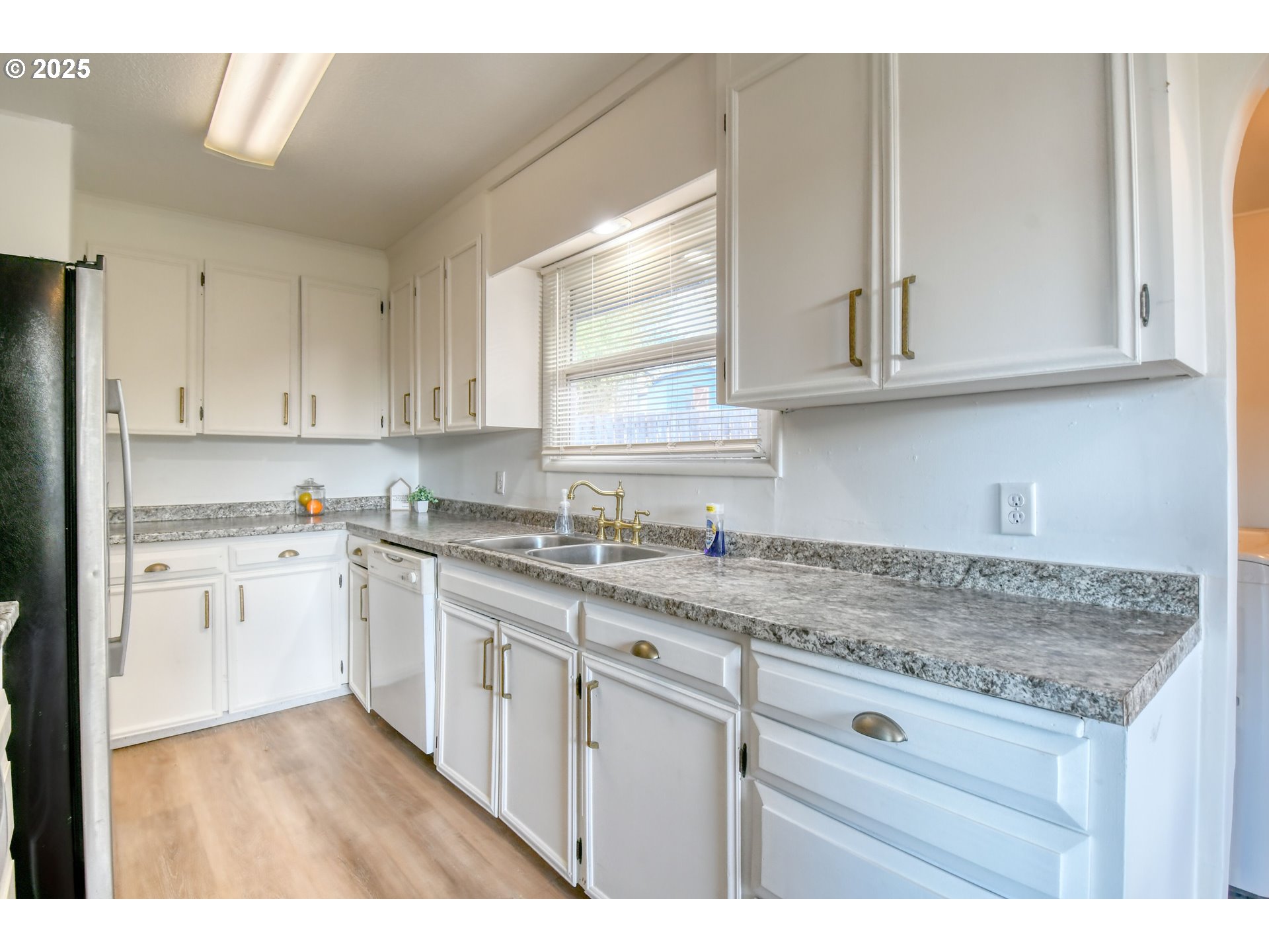 20 Northeast Nelson Drive Pendleton, OR 97801 - Photo 7 of 35 a kitchen with granite countertop white cabinets and white appliances