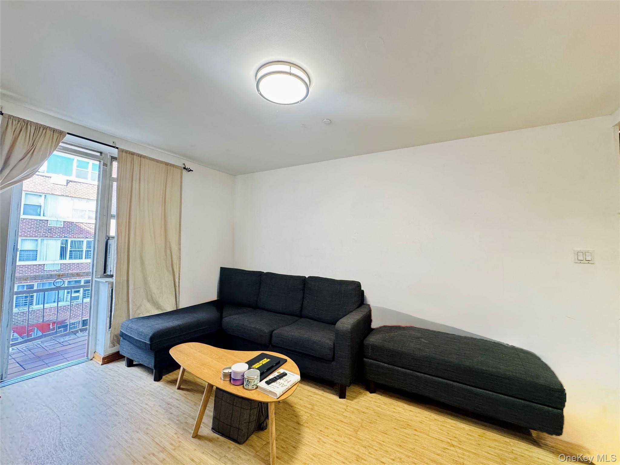 4232 82nd Street, Unit 6B Queens, NY 11373 - Photo 2 of 10 a living room with furniture and a couch