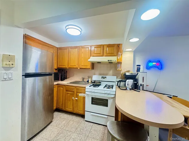 a kitchen with a stove a refrigerator and a sink