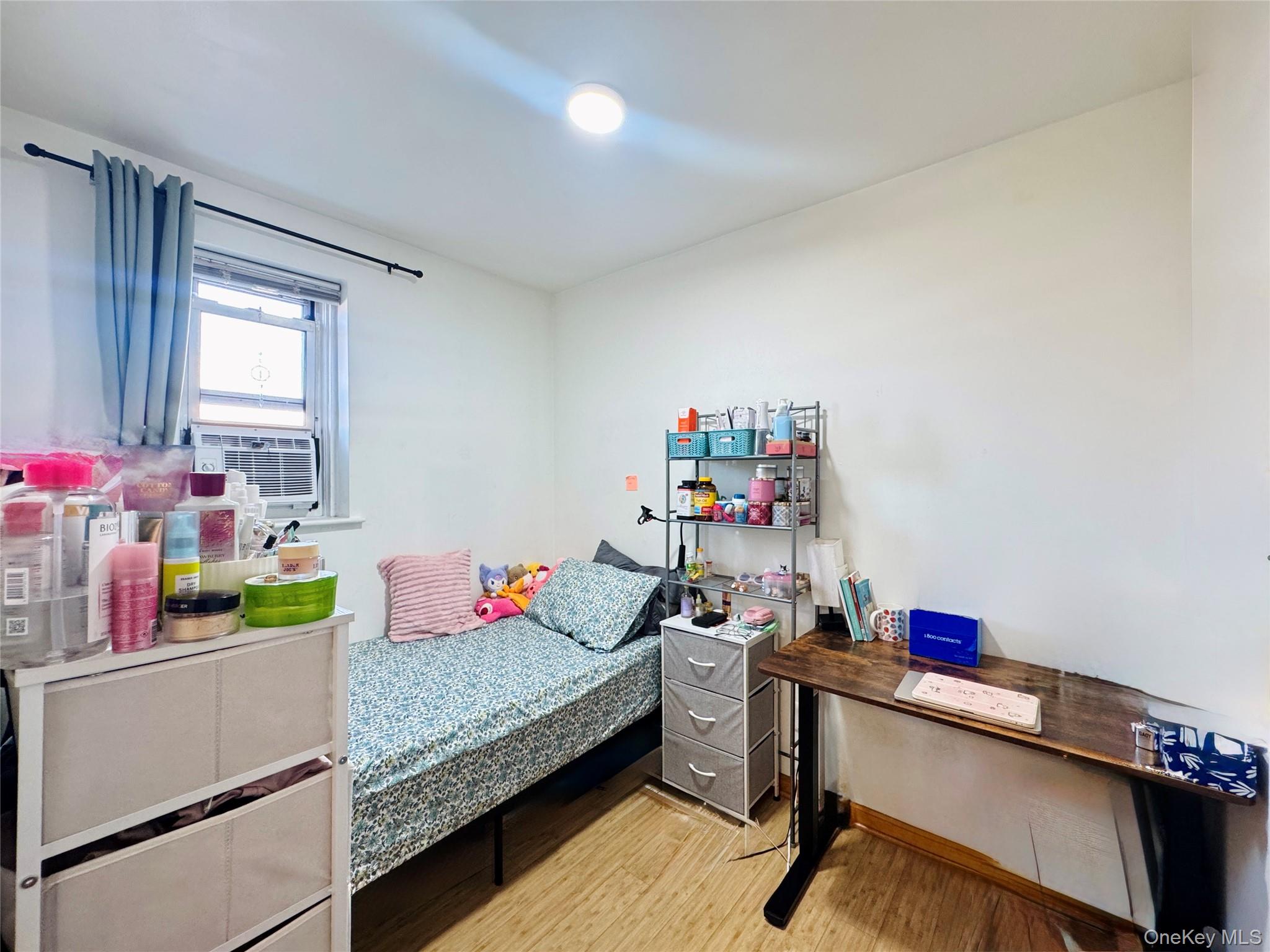 4232 82nd Street, Unit 6B Queens, NY 11373 - Photo 8 of 10 a bedroom with a bed and a table