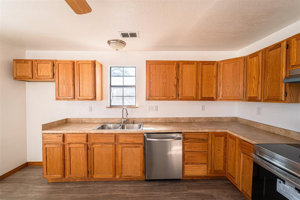 618 Oak Street Clyde, TX 79510 - Photo 13 of 39 a kitchen with a sink and cabinets