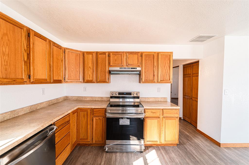 618 Oak Street Clyde, TX 79510 - Photo 14 of 39 a kitchen with granite countertop a stove and a sink