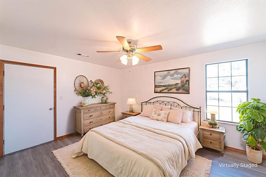 618 Oak Street Clyde, TX 79510 - Photo 15 of 39 a bedroom with a bed and a potted plant