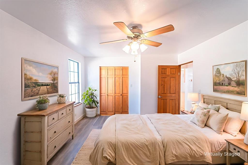 618 Oak Street Clyde, TX 79510 - Photo 20 of 39 a bedroom with a bed and a chandelier