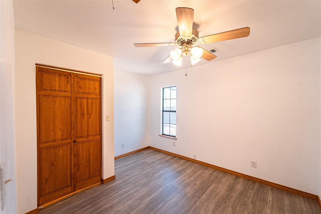 618 Oak Street Clyde, TX 79510 - Photo 23 of 39 a view of empty room with wooden floor and fan
