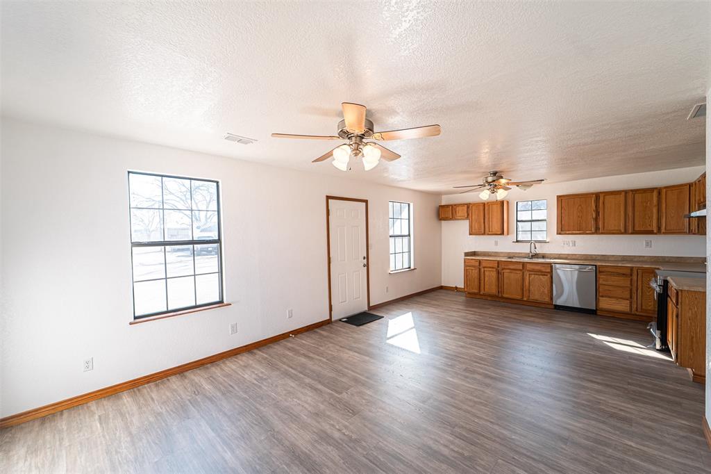 618 Oak Street Clyde, TX 79510 - Photo 6 of 39 a view of a kitchen with furniture and wooden floor