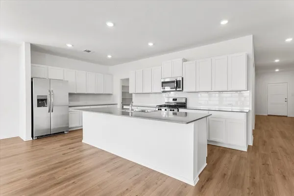 a kitchen with wooden cabinets and white stainless steel appliances